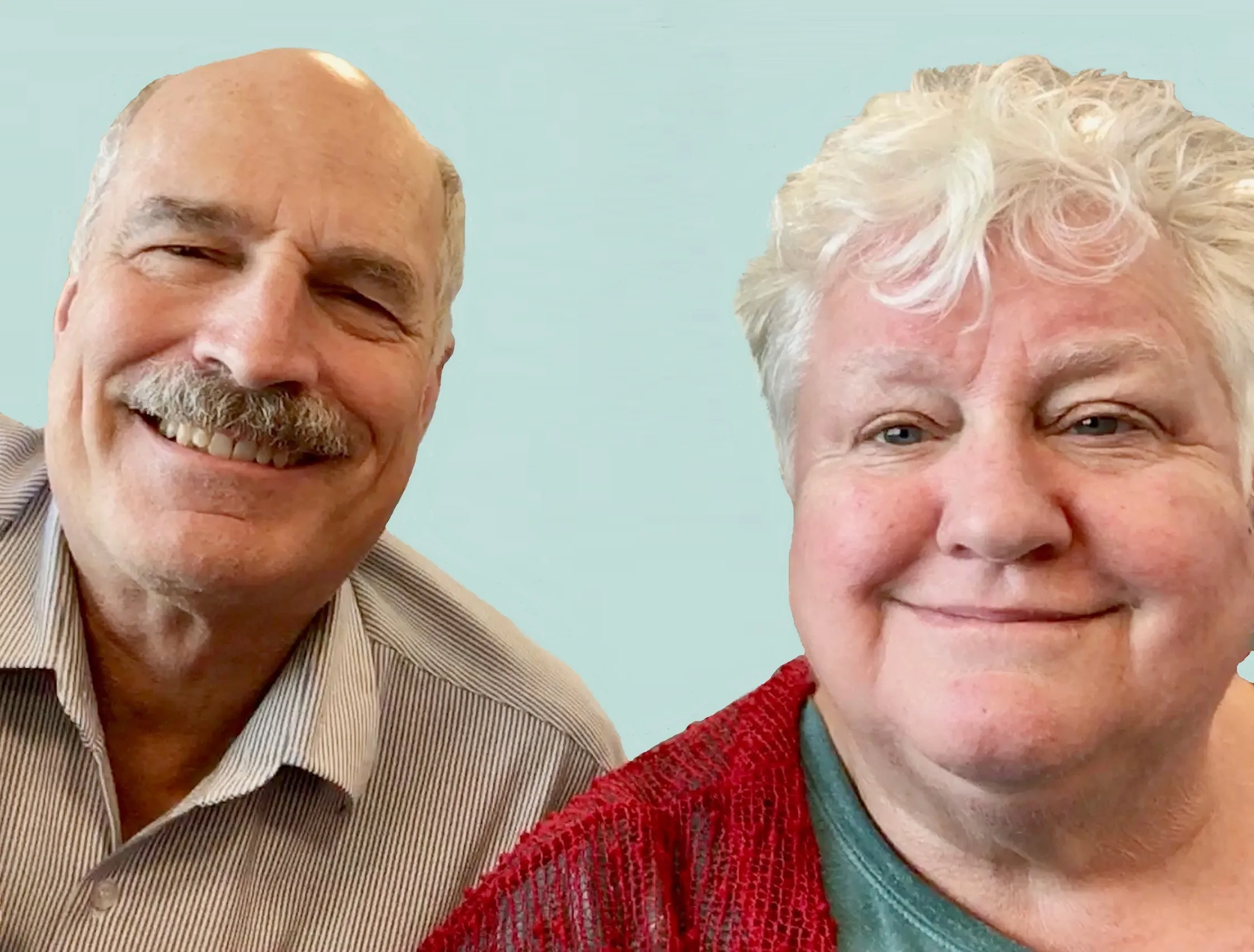 Smiling elderly man with mustache in striped shirt and smiling elderly woman with curly white hair wearing a red cardigan.